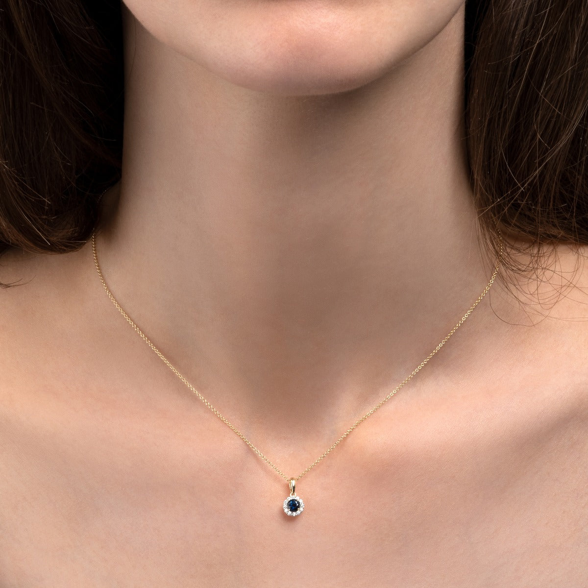 solid gold necklace with blue sapphire and diamonds