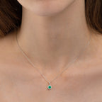 dainty white gold necklace with emerald and diamonds