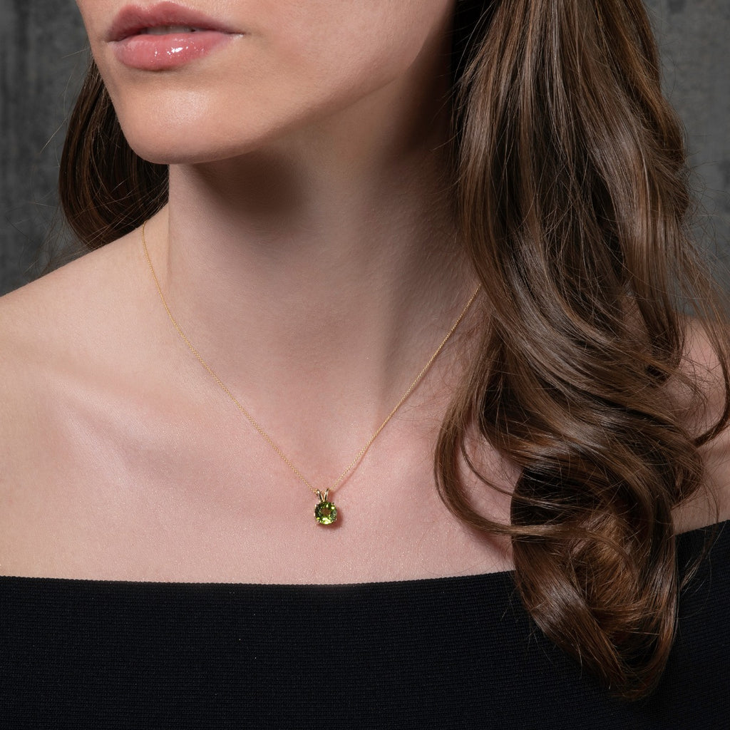 9K gold pendant necklace with a round peridot gemstone