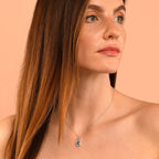 5mm x 8mm Blue Topaz with 0.15ct Diamond pendant in 9K white gold
