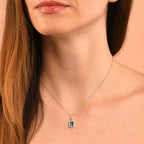 5mm x 8mm Blue Topaz with 0.15ct Diamond pendant in 9K white gold
