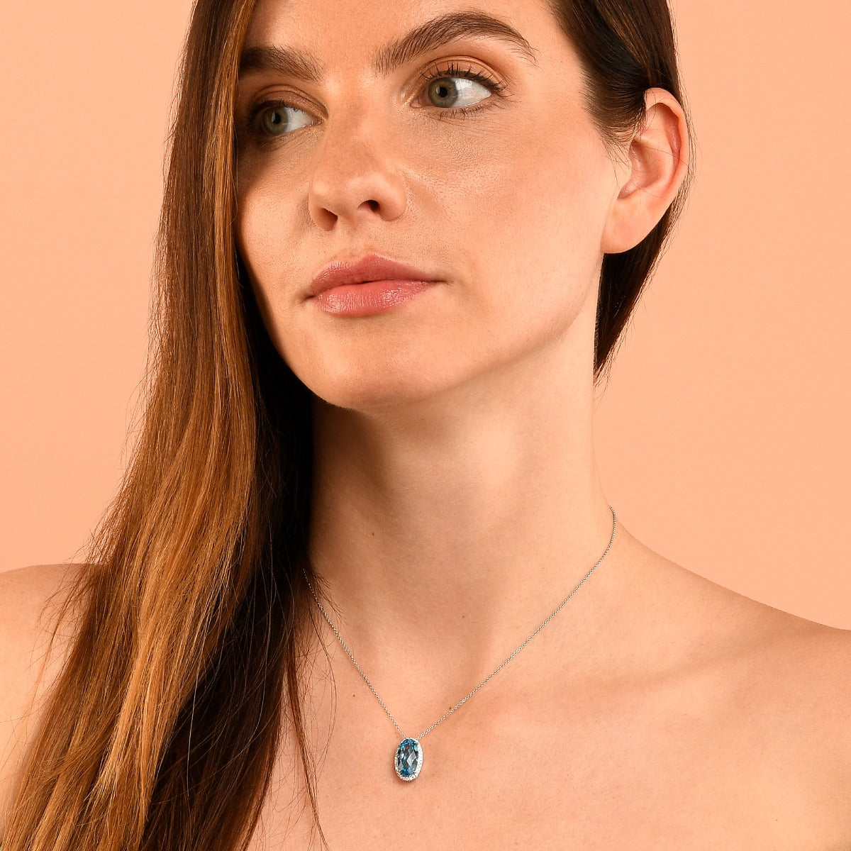 8mm x 14mm Blue Topaz with 0.16ct Diamond pendant in 9K white gold