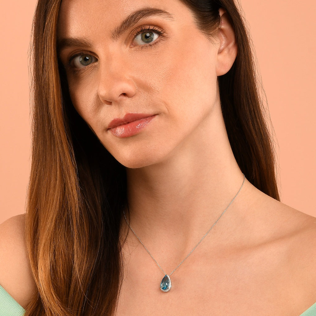 8mm x 13mm Blue Topaz with 0.17ct Diamond pendant in 9K white gold
