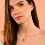 8mm x 13mm Blue Topaz with 0.17ct Diamond pendant in 9K white gold