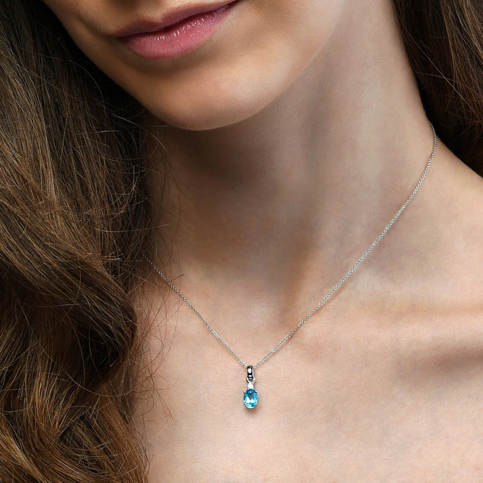 0.75ct Blue Topaz With 0.04ct Diamond Pendant In 9K White Gold
