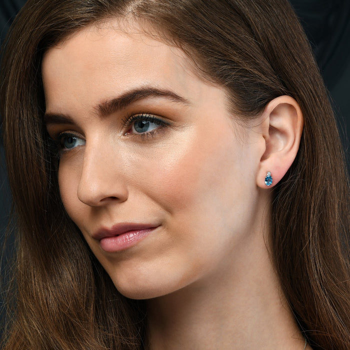 1.50ct Blue Topaz And 0.07ct Diamond Stud Earrings In 9K White Gold
