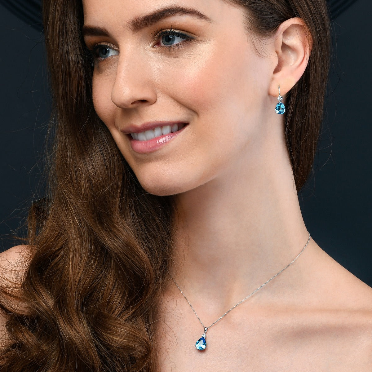 6.00ct Pear Shape Blue Topaz & 0.10ct Diamond Earrings 9K White Gold