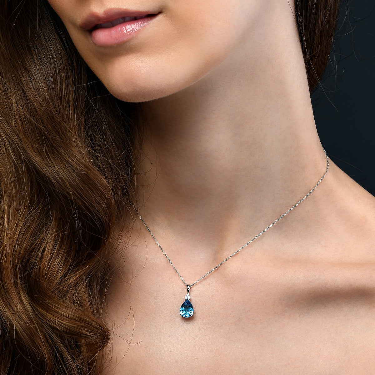 Pear Shaped Blue Topaz with 0.05ct Diamond pendant in 9K white gold