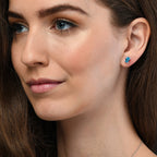 Oval Blue Topaz and 0.05ct diamond stud earrings in 9K white gold