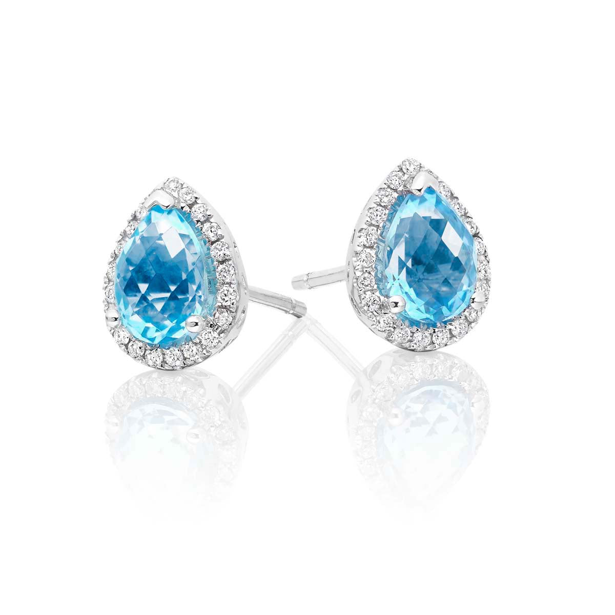 5mm x 7mm Blue Topaz and 0.16ct diamond stud earrings in 9K white gold