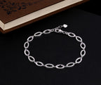 Sterling Silver Bracelet for Women Oval Link & White Cubic Zirconia near book