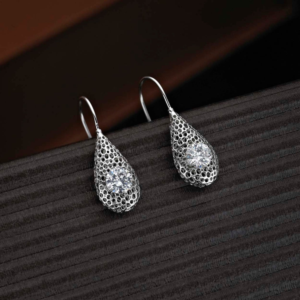 Cacoon Sterling Silver Drop Earrings with Round White Cubic Zirconia on black surface