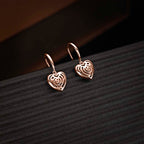 Rose Gold Plated Dangling Heart 925 Sterling Silver Drop Earrings on black surface