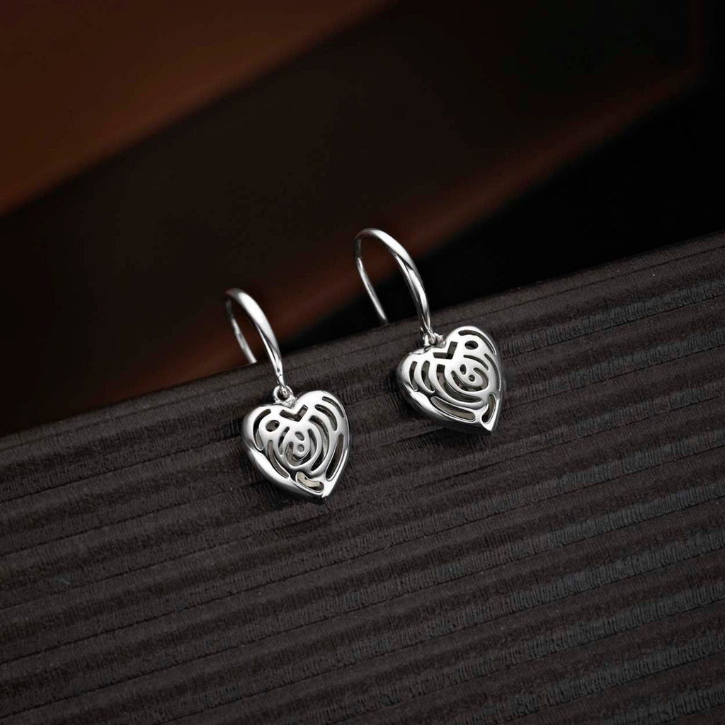 Dangling Heart 925 Sterling Silver Drop Earrings on black surface