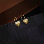 Gold Plated Webbed Heart 925 Sterling Silver Drop Earrings on black surface