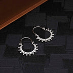 Solar 925 Sterling Silver Hoop Earrings on black surface