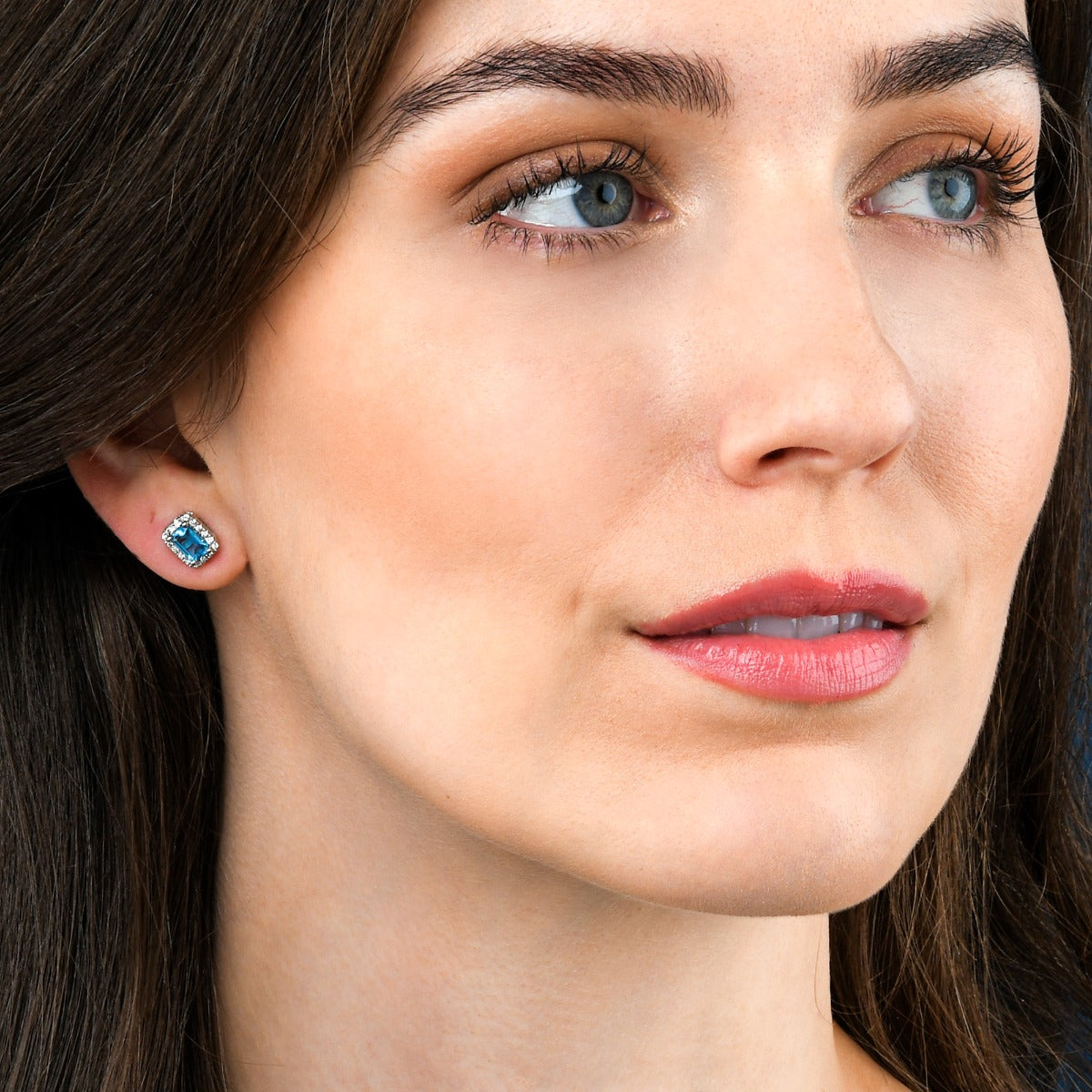 4mm x 6mm Blue Topaz and 0.15ct diamond stud earrings in 9K white gold