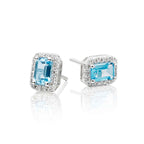4mm x 6mm Blue Topaz and 0.15ct diamond stud earrings in 9K white gold