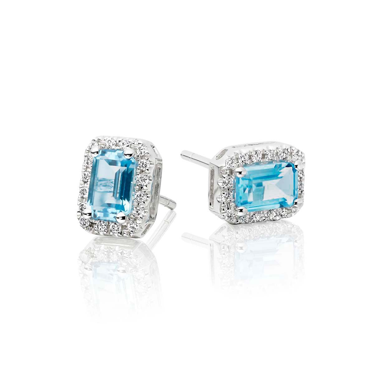 4mm x 6mm Blue Topaz and 0.15ct diamond stud earrings in 9K white gold