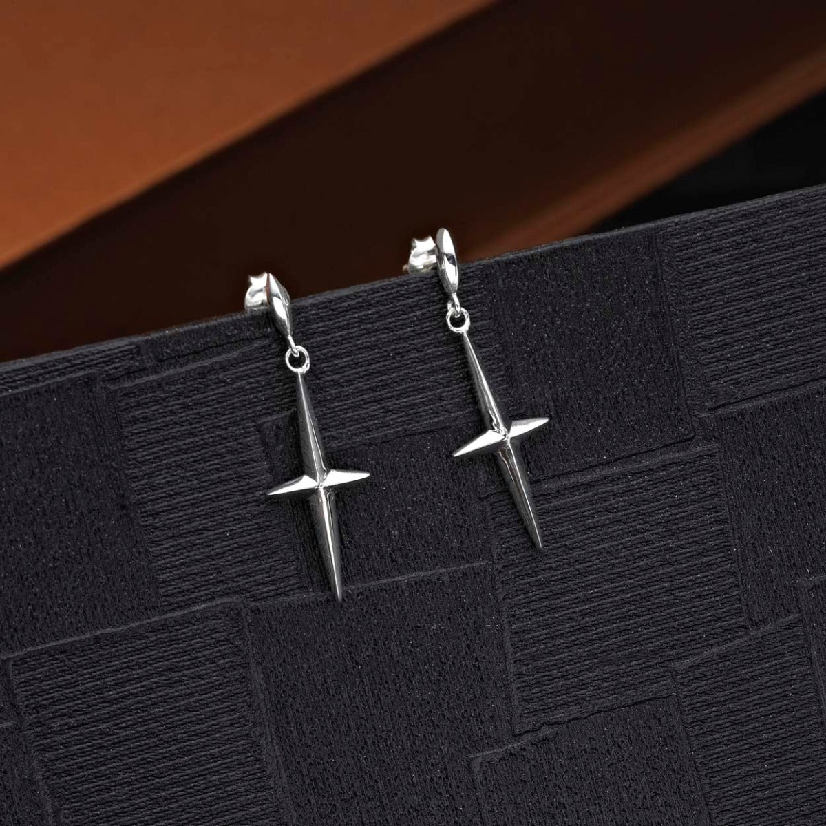 Simple Cross Drop Earrings in 925 Sterling Silver on black surface
