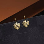 Swirling Heart Gold Plated 925 Sterling Silver Dangle Earrings on black surface