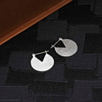 Brushed Finish Disk Sterling Silver Hoop Earrings on black surface