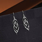 Dangling Spiral 925 Sterling Silver Twirl Earrings on black surface
