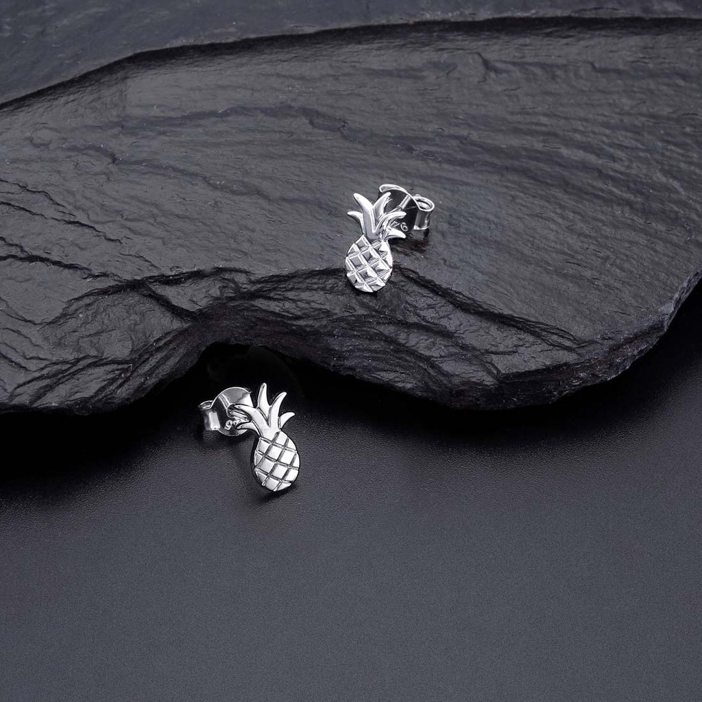 Flat Pineapple Stud Earrings in Sterling Silver on rocks