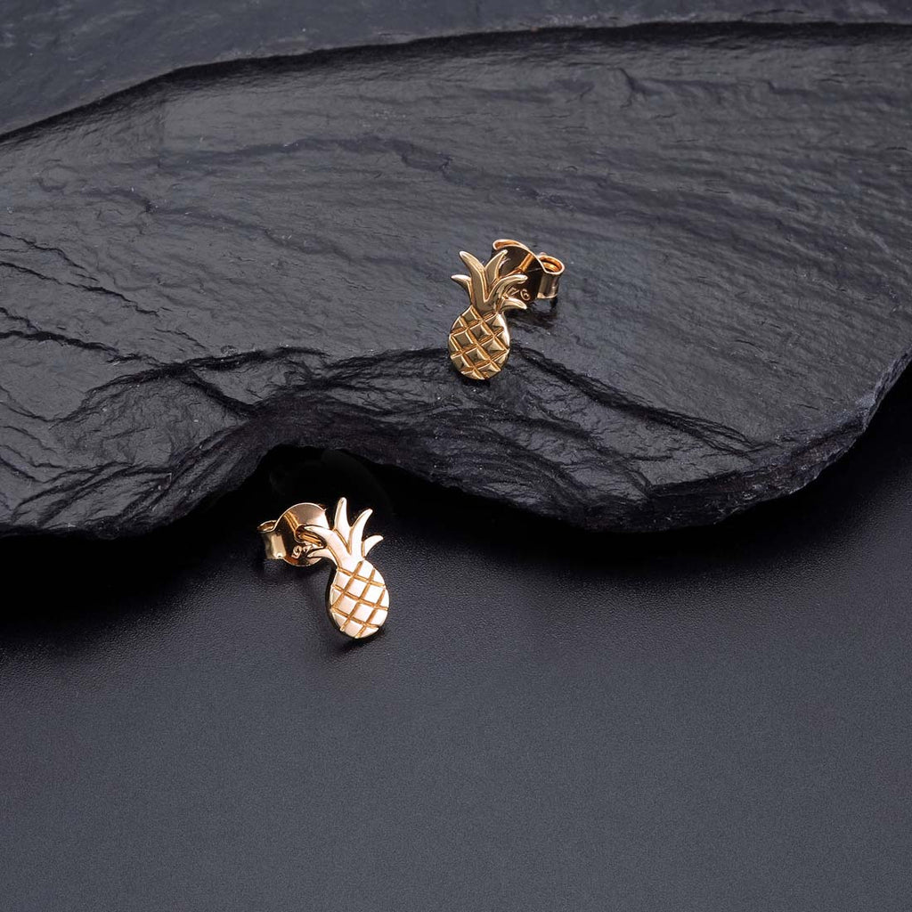 Gold Flat Pineapple Stud Earrings in Sterling Silver on rocks