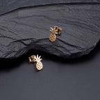 Gold Flat Pineapple Stud Earrings in Sterling Silver on rocks