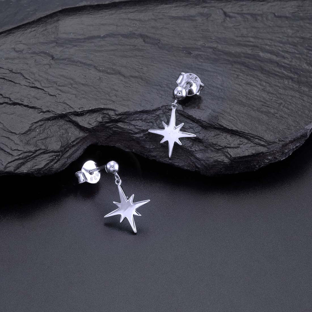 Simple Star Drop Earrings in Polished Sterling Silver on rock