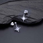 Simple Star Drop Earrings in Polished Sterling Silver on rock