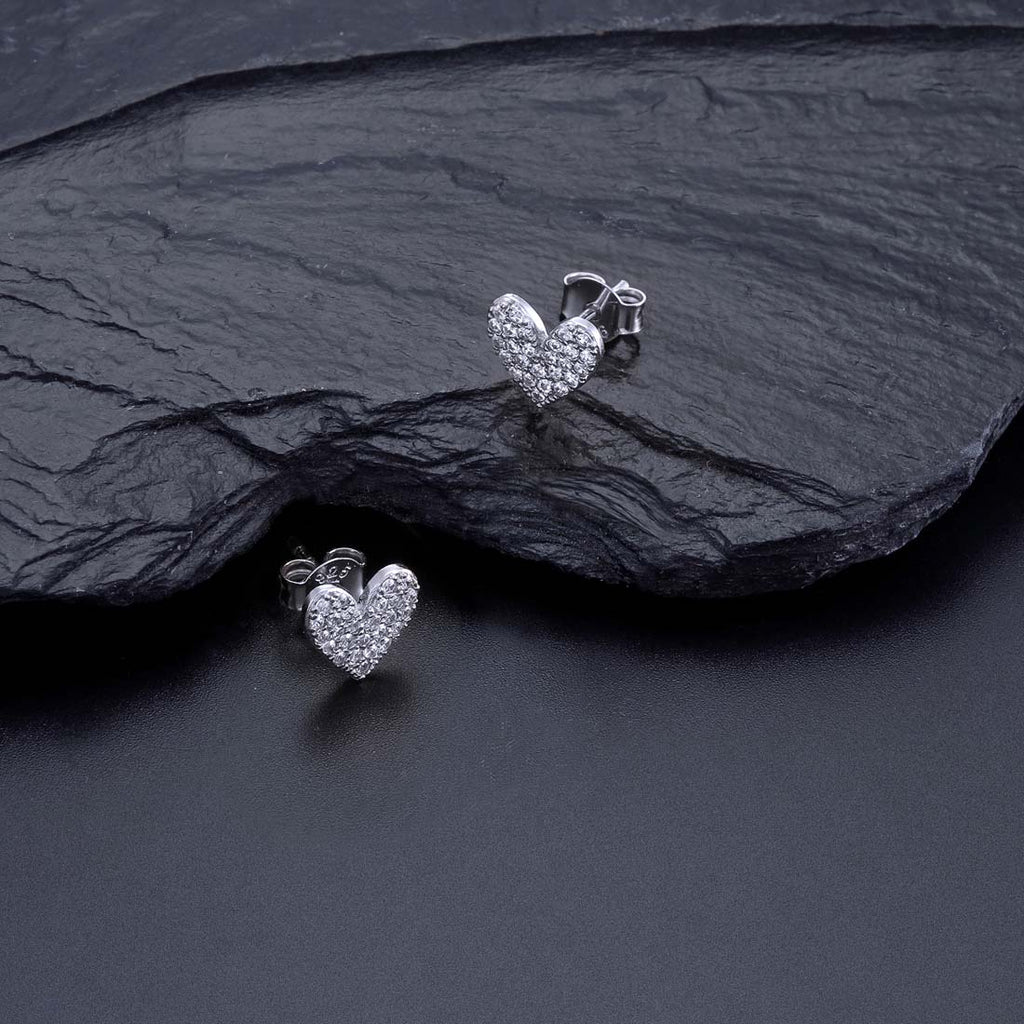 Pave Heart Stud Earrings with Cubic Zirconia in Sterling Silver on rocks