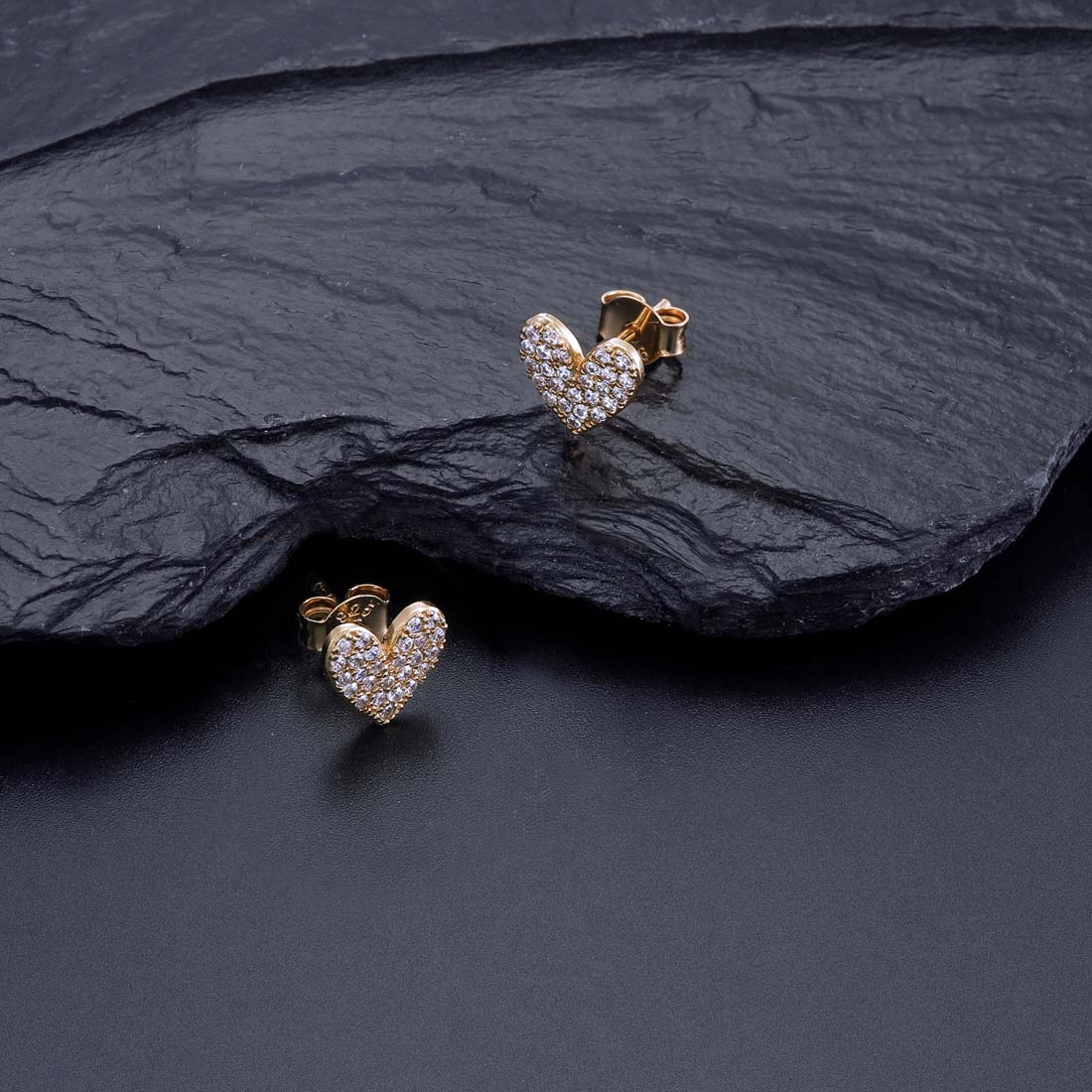 Gold Pave Heart Stud Earrings with Cubic Zirconia in Sterling Silver on rock