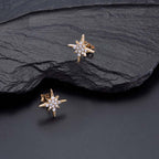 Gold Sparkling Star Stud Earrings Cubic Zirconia in Sterling Silver on rocks