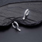Zirconia Drop Hoop Earrings with Cubic Zirconia in Sterling Silver on rocks