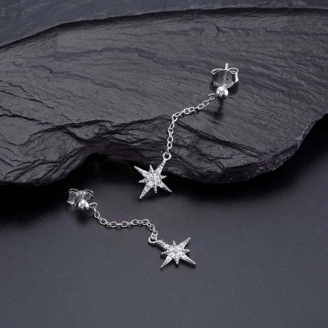 Long Star Drop Earrings Cubic Zirconia in Sterling Silver on rocks
