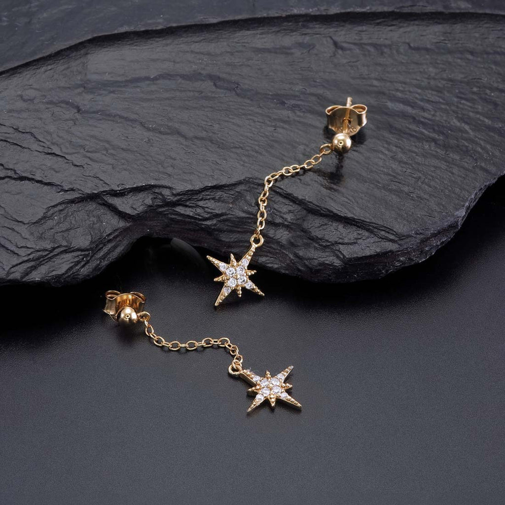 Gold Long Star Drop Earrings Cubic Zirconia in Sterling Silver on rocks
