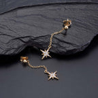 Gold Long Star Drop Earrings Cubic Zirconia in Sterling Silver on rocks