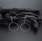 Hanging Circle Earrings in Sterling Silver on rocks