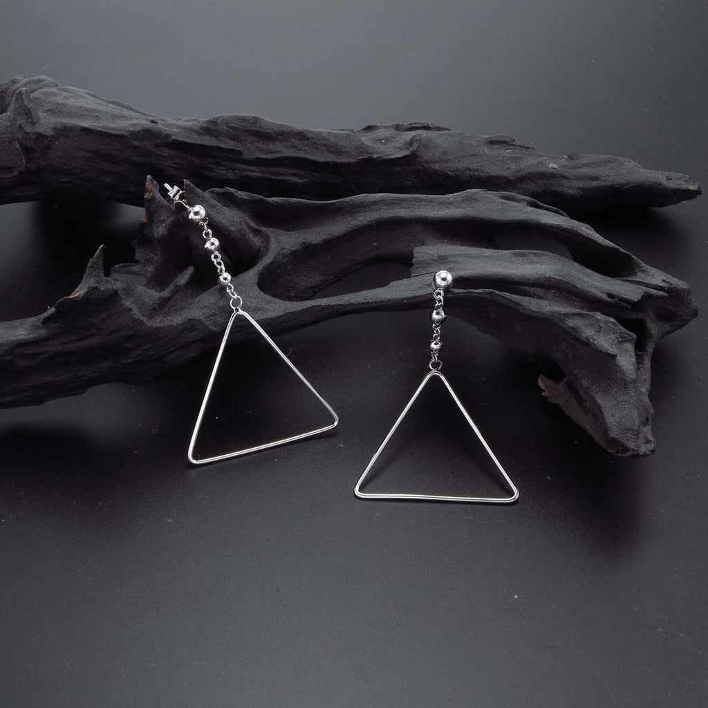 Hanging Triangle Earrings in Sterling Silver on rock