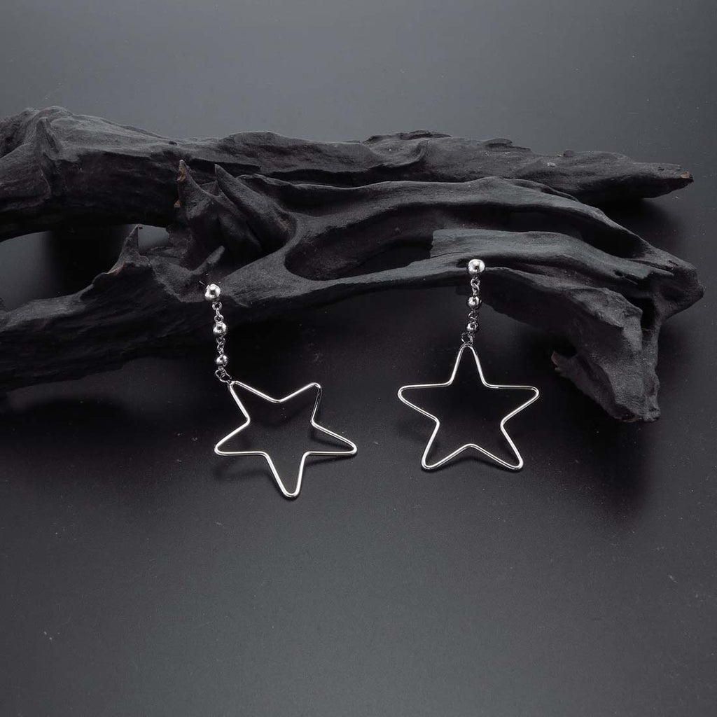 Hanging Star Earrings in Sterling Silver on rocks