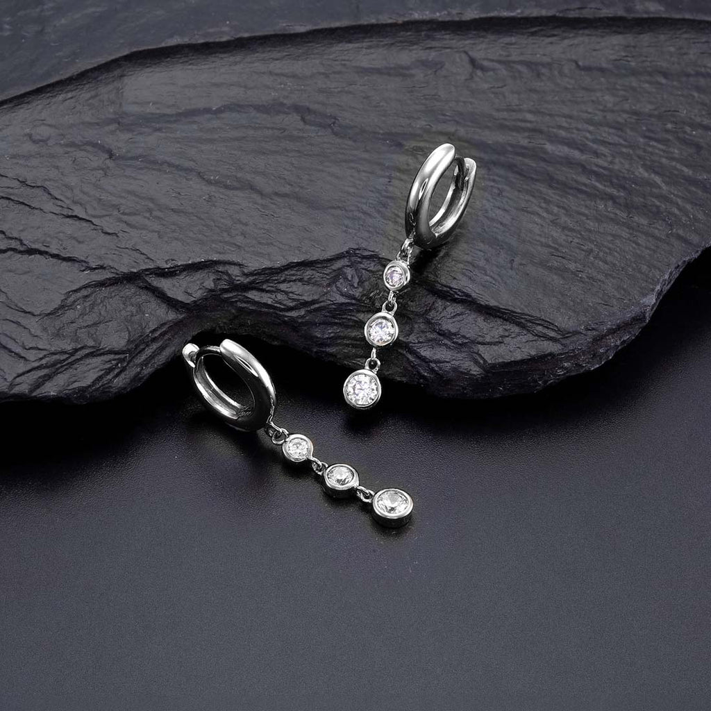 Trilogy Hoop Earrings with White Cubic Zirconia in Sterling Silver on rock