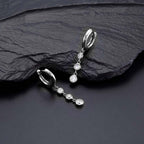 Trilogy Hoop Earrings with White Cubic Zirconia in Sterling Silver on rock