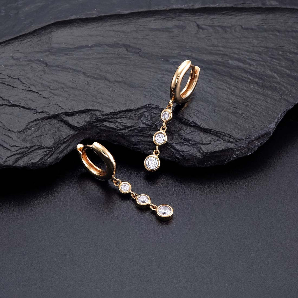 Gold Trilogy Hoop Earrings Cubic Zirconia in Sterling Silver on rock