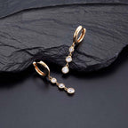 Gold Trilogy Hoop Earrings Cubic Zirconia in Sterling Silver on rock