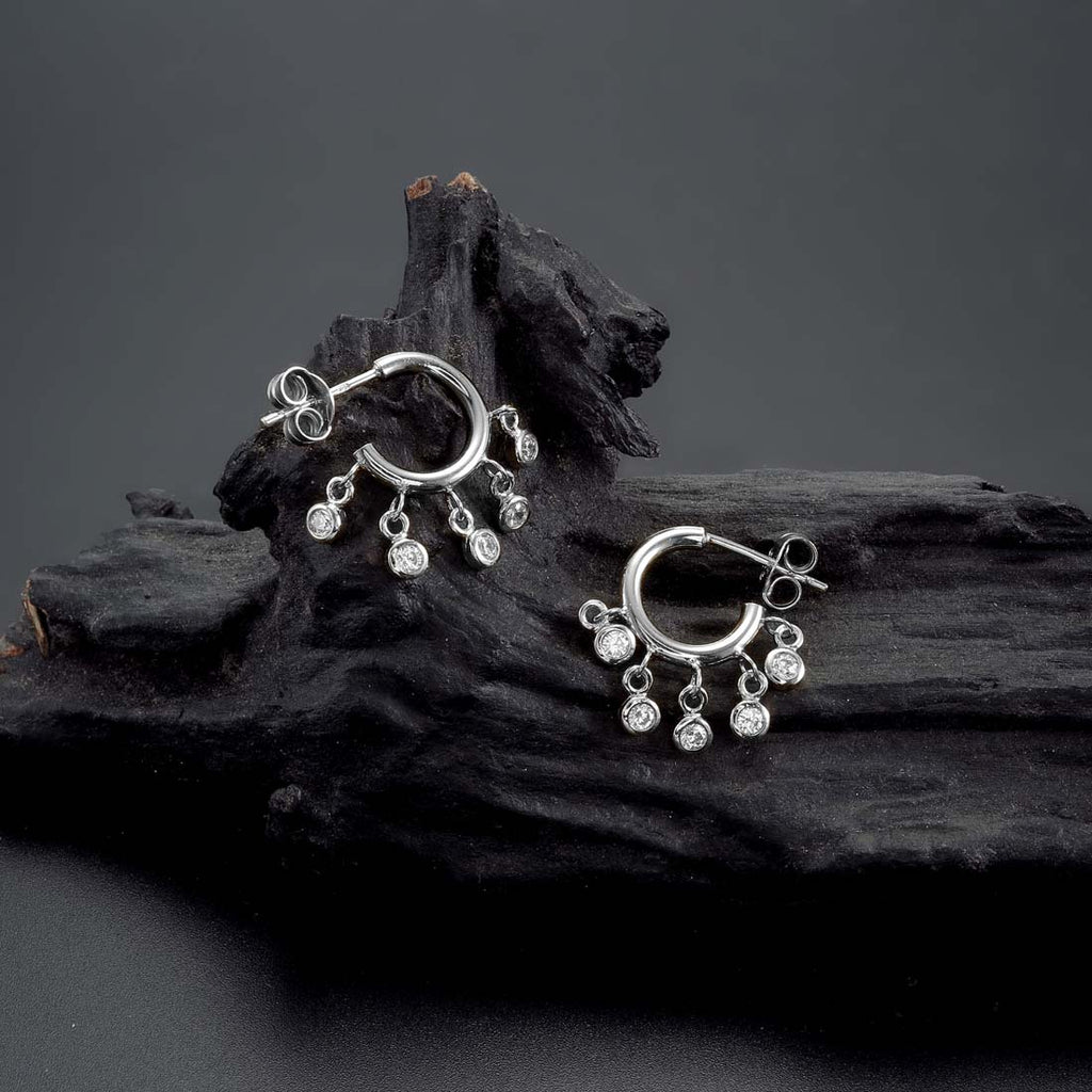 Mini Shaker Hoop Earrings with Cubic Zirconia in Sterling Silver on rocks
