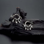 Mini Shaker Hoop Earrings with Cubic Zirconia in Sterling Silver on rocks