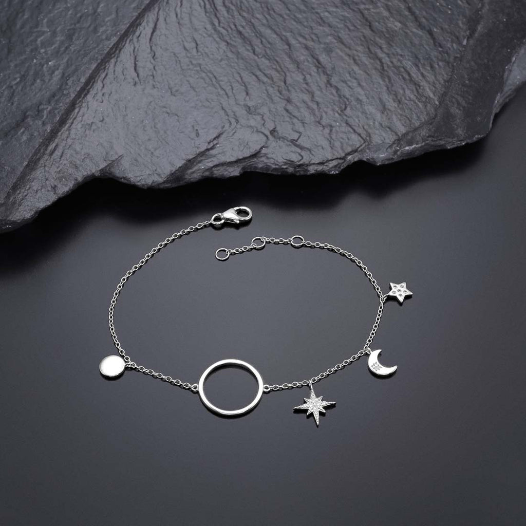 Sterling Silver Ladies Moon & Star Bracelet with Cubic Zirconia near black rock