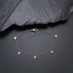 Triangle Charm Bracelet Gold Plated Sterling Silver & Cubic Zirconia near black rock
